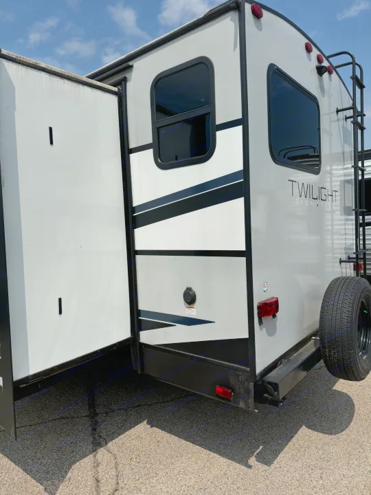Modern RV rental, detailed rear/side view with slide-out extended, showing windows, ladder, and spare tire.. Heartland Other 2021