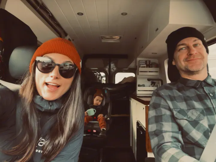 A happy family of three smiles in their cozy RV rental camper van, ready for their road trip.. Mercedes-Benz Sprinter 2020