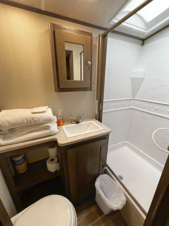 Compact RV rental bathroom featuring a shower, sink, and toilet, optimized for travel comfort and space efficiency.. Cruiser Rv Corp Other 2018