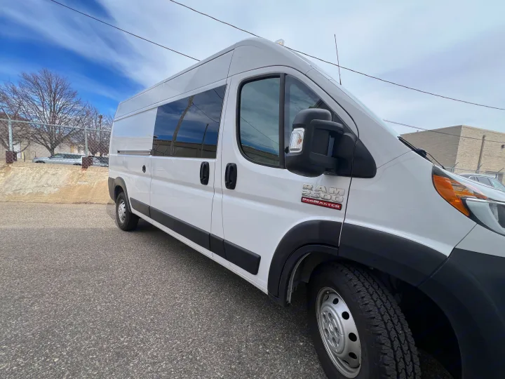 White Ram ProMaster 2500 cargo van, ideal for RV rental conversion, parked under a blue sky.. Ram Promaster 2500 2021