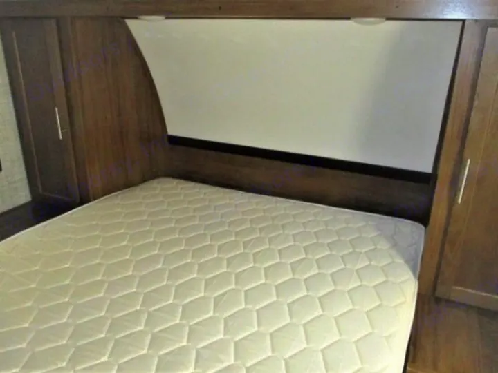 A cozy RV rental bedroom with a white mattress between wooden cabinets. Ready for comfortable sleep.. Gulf Stream Kingsport 2020