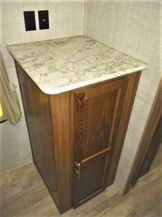 RV rental interior: Dark wood cabinet with marble-look counter, wall outlets. Provides functional storage.. Gulf Stream Kingsport 2020
