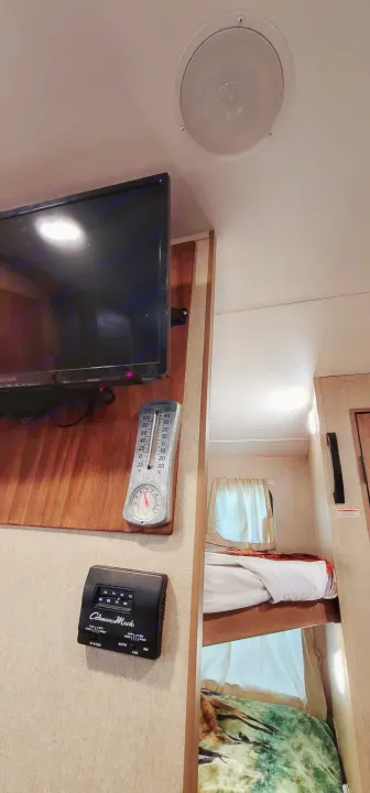RV rental interior: TV, ceiling speaker, thermometer, Coleman-Mach thermostat, and bunk beds for comfort.. Starcraft AR-One Maxx 2017