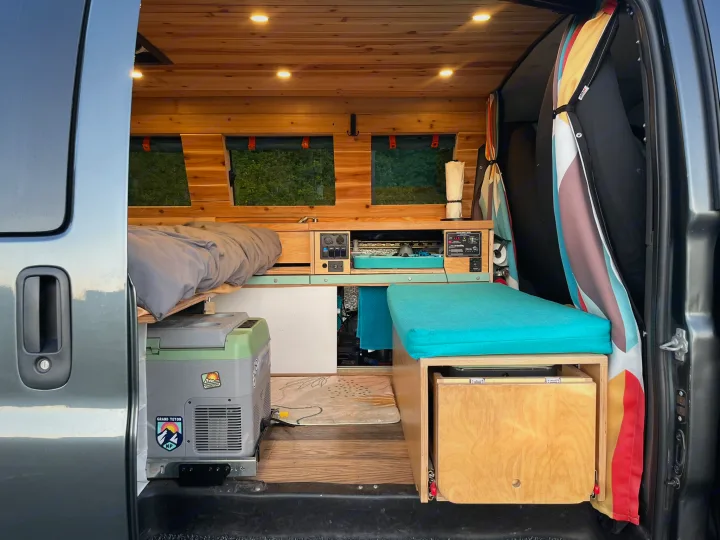 Experience mobile living! This RV rental boasts a custom wood interior, bed, fridge, and functional living space.. Gmc Savanna C1500 2014