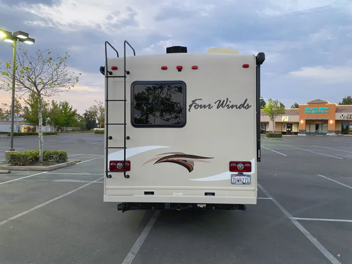 Four Winds RV rental in an empty parking lot near Willow Rock Pet Hospital, perfect for travel adventures.. Thor Four Winds 2017