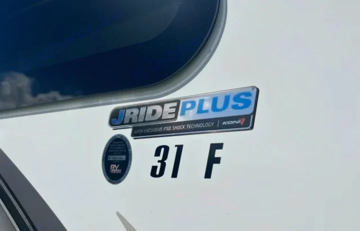Close-up of an RV rental side, highlighting J-Ride Plus with Koní FSD shock tech, and "31 F" model.. Jayco Greyhawk 2021