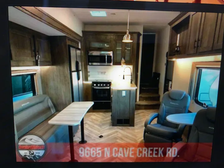 Spacious RV interior with modern kitchen, dining area, and comfortable seating, ideal for your next RV rental.. Forest River Stealth 2020