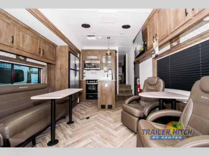 RV rental: Interior of a Stealth toy hauler with a full kitchen, living area, and versatile rear space.. Forest River Stealth 2020