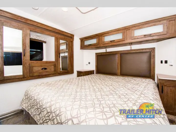 Spacious RV bedroom perfect for your rv rental, with a comfy bed, overhead storage & built-in mirrored wardrobes.. Forest River Stealth 2020