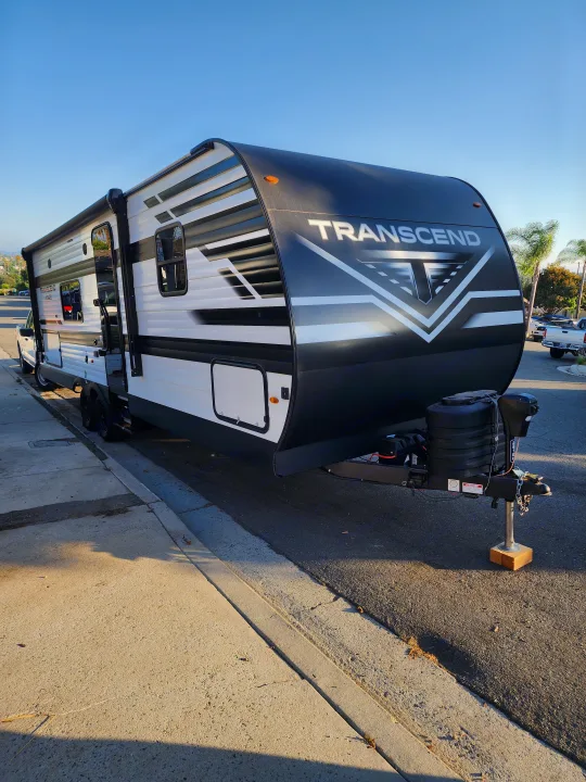 Transcend RV rental: A striking black and white travel trailer parked, ready for your next adventure.. Grand Design Transcend Xplor 2024
