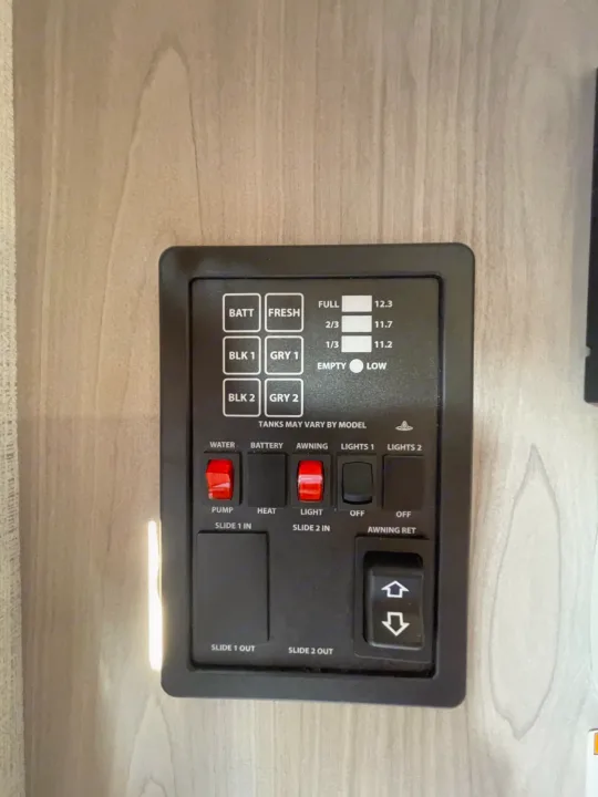 RV rental control panel: Monitor tank levels (fresh, gray, black), battery, plus controls for pump, heat, lights, awning, and slide-outs.. Keystone Springdale 1800BH 2024