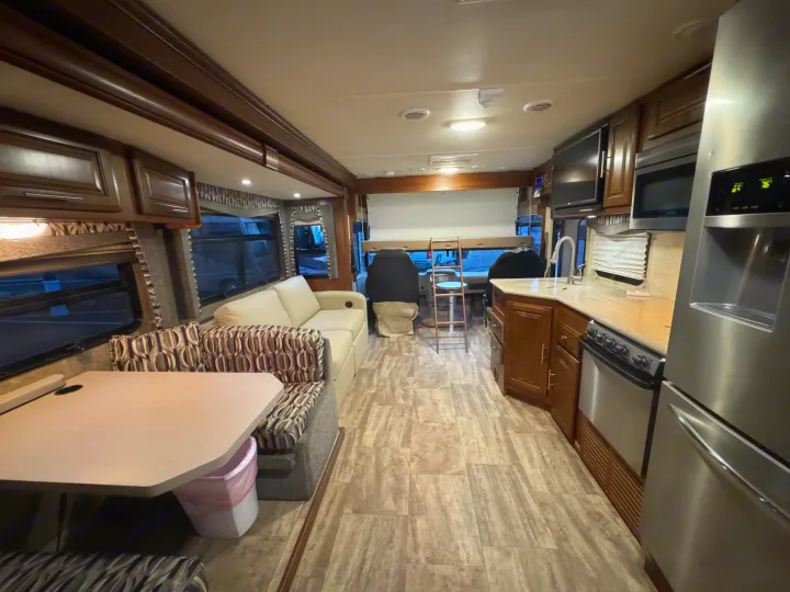 Spacious RV rental interior featuring a full kitchen, comfortable living area, and dinette setup.. Forest River Georgetown 2018