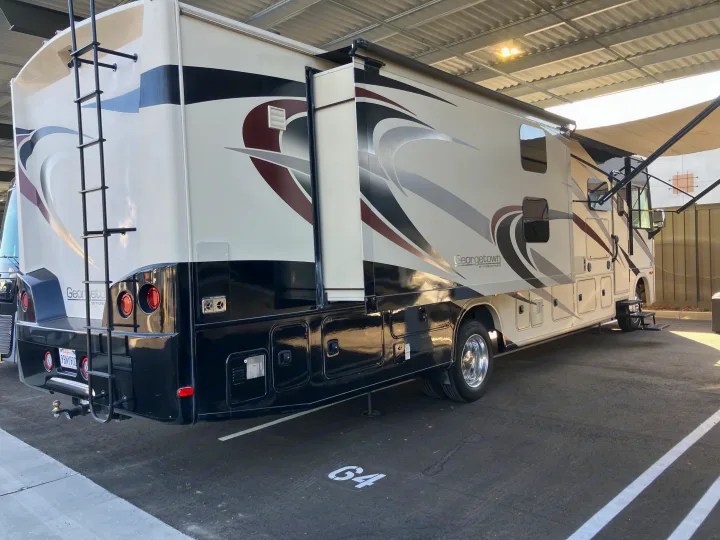 Spacious Class A rv rental, a Georgetown motorhome, parked in spot G4 with slide-out extended and awning out.. Forest River GEORGETOWN GT5 2019