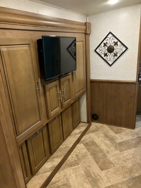 Explore this RV rental's modern interior featuring a mounted TV, extensive storage cabinets, and stylish decor.. Forest River GEORGETOWN GT5 2019