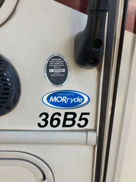 Side of an RV rental motorhome showing certification and MORryde chassis stickers, plus unit number 36B5.. Forest River GEORGETOWN GT5 2019