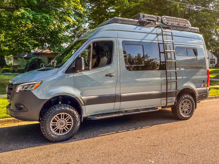 Discover this custom light grey Mercedes Sprinter adventure camper van with off-road tires & roof rack, ideal for rv rental.. Mercedes-Benz Sprinter 2024