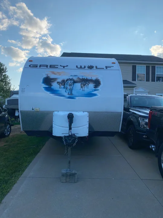 Front view of a Grey Wolf travel trailer, ideal for RV rental, featuring a striking wolf graphic.. Forest River Cherokee Grey Wolf 2012