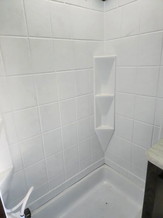 Bright, clean shower stall with built-in shelves in an RV rental.. Cruiser RV MPG Ultra Lite 2020