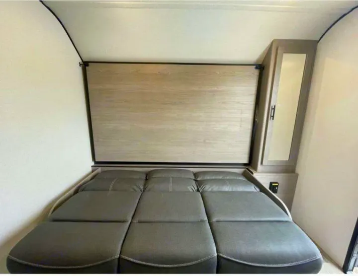 This RV rental features a clever interior with a versatile sofa bed and a mirrored cabinet for compact comfort.. Dutchmen Coleman 1905BH 2024