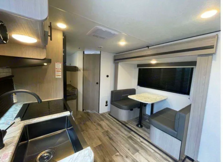 Step inside this cozy rv rental, showcasing a functional kitchen, comfortable dinette, and convenient bunk beds.. Dutchmen Coleman 1905BH 2024