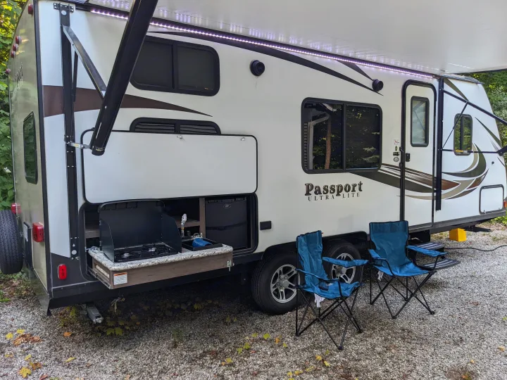 This Passport ULTRA-LITE RV rental features an outdoor kitchen, LED-lit awning, and camping chairs for your adventure.. Keystone RV Passport Ultra Lite 2018