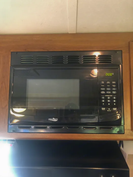 An integrated High Pointe microwave oven, typically found in an rv rental, showing its digital display and control panel.. Keystone RV Springdale 2017
