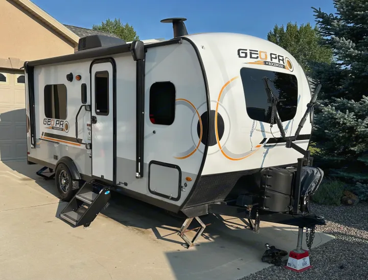 White and grey Geo Pro travel trailer, ready for an exciting rv rental adventure, parked on a sunny driveway.. Forest River GeoPro 2022