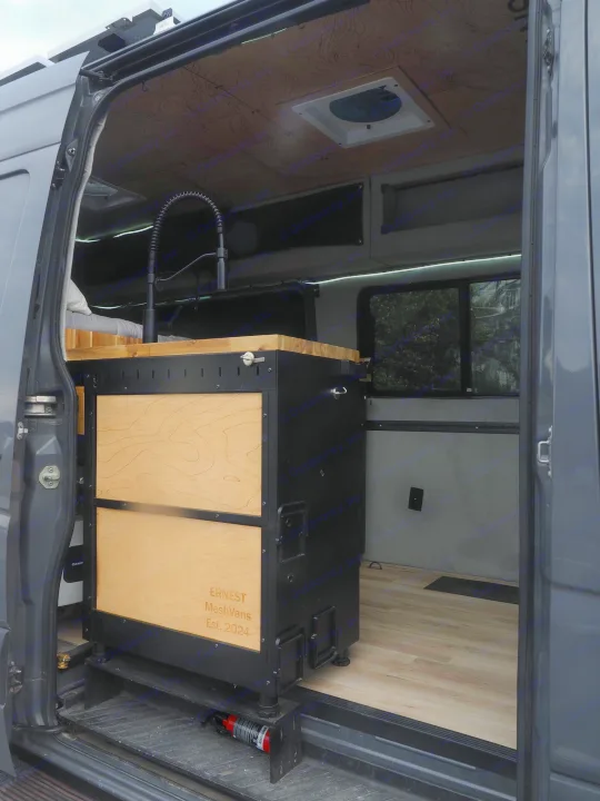 Inside this stylish RV rental: a modern camper van conversion with modular kitchen, bed, and custom wood details.. Mercedes Sprinter 2016