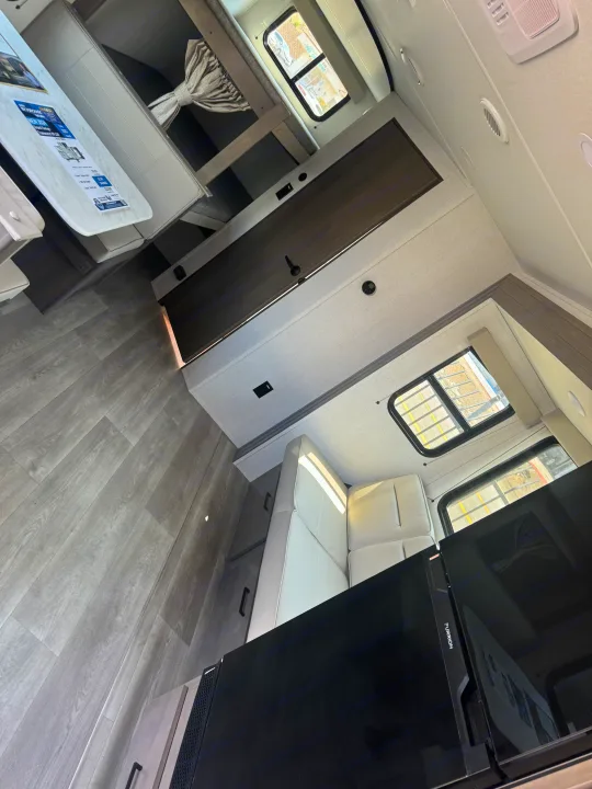 Spacious Grand Design RV rental interior with a cozy dinette, bunk beds, and a modern Furrion refrigerator for your next adventure.. Grand Design Transcend Xplor 2024