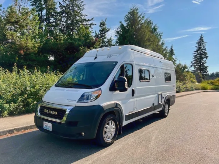 A white Ram rv rental camper van, parked outdoors and ready for your next travel adventure.. Winnebago Winnebago 2023