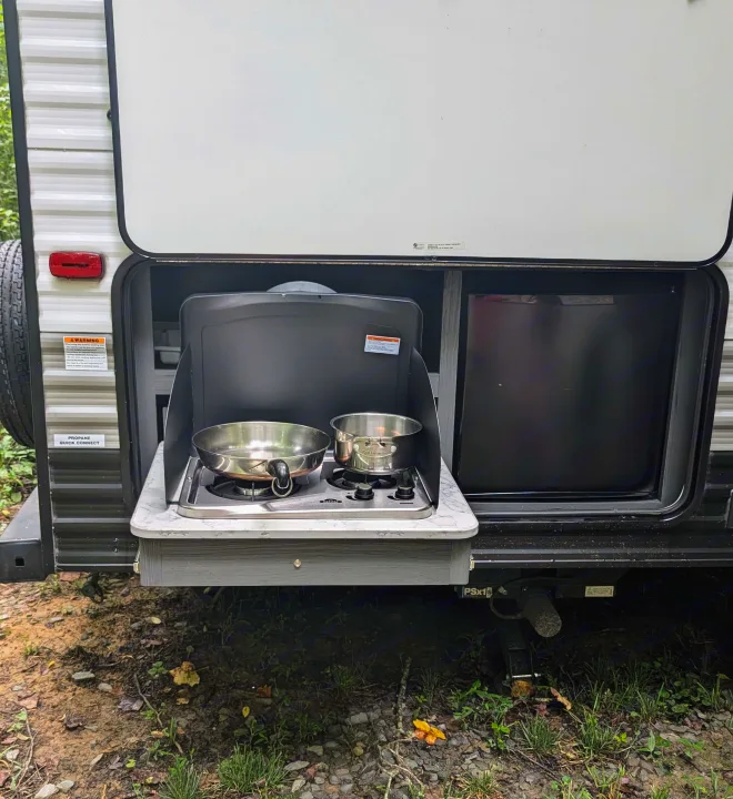 This RV rental features a pull-out outdoor kitchen with a two-burner stove, pan, pot, and mini-fridge for easy camping meals.. Aspen Trail LE 2022