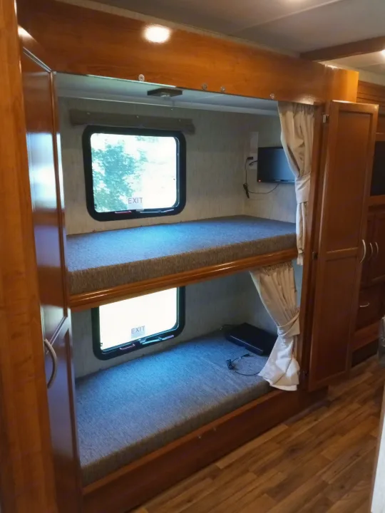 This RV rental features a cozy bunk bed setup.. Forest River Coachmen Mirada 2018