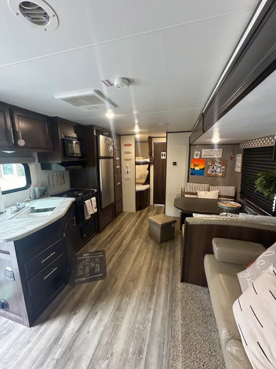 Spacious RV rental interior featuring a full kitchen, dinette, cozy living area, and bunk beds.. Jayco Jay Flight SLX 2019