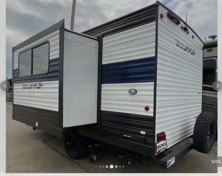 RV rental: A white and blue Wolf Pup travel trailer with an extended slide-out, parked for viewing.. Forest River Cherokee Wolf Pup 16KHWBL 2024