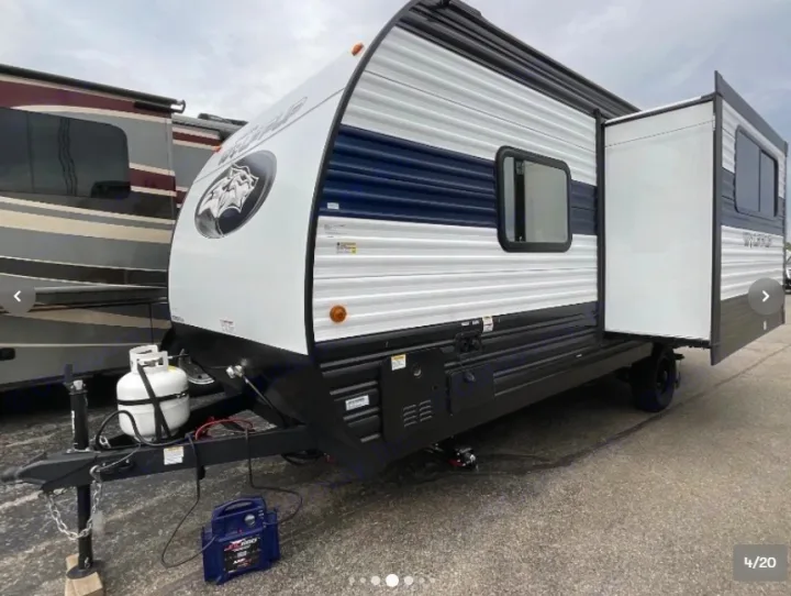 Ready for adventure! This spacious travel trailer RV rental, white with blue accents and a slide-out, promises a great road trip.. Forest River Cherokee Wolf Pup 16KHWBL 2024