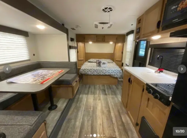 Spacious RV rental interior featuring a full kitchen, comfortable dinette, and private bedroom area.. Forest River Cherokee Wolf Pup 16KHWBL 2024