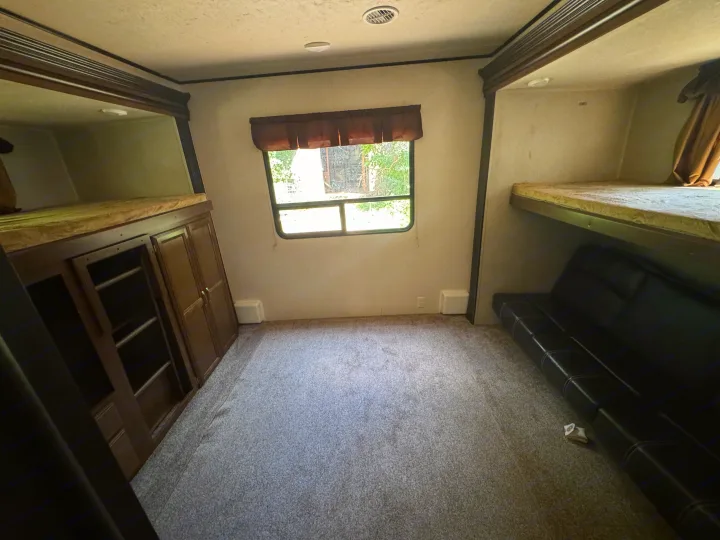 RV rental bunkhouse: spacious interior with bunk beds, sofa, and storage cabinets for comfortable travel.. Forest River Salem Villa Classic Destination 2017