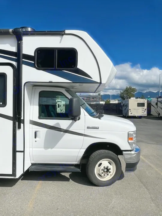 This white Class C RV rental, shown from the side on asphalt, is an ideal camper or motorhome for your next adventure.. Forest River Forester 2022