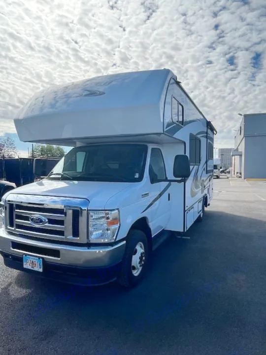 Bright white Jayco Class C RV rental, parked on asphalt under a cloudy sky. An ideal motorhome for your next road trip.. Forest River Forester 2022