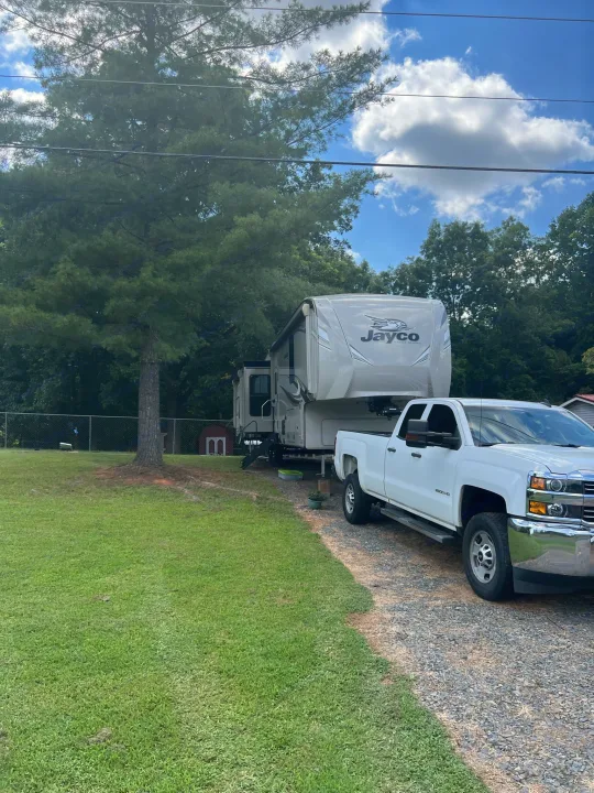Jayco fifth-wheel RV rental and pickup truck in a scenic outdoor setting, ready for adventure.. Jayco Eagle 2020