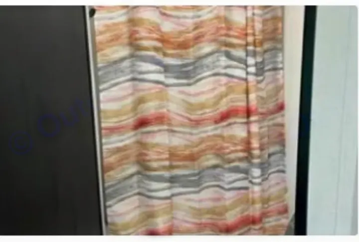 This RV rental features a stylish, wavy curtain in earthy and coral tones, perfect for privacy on your travels.. Dutchmen Kodiak SE 2024