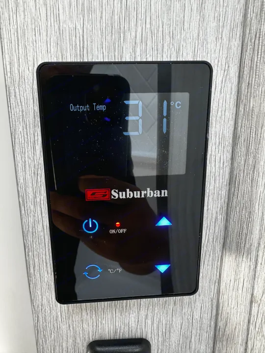 An RV rental's Suburban digital control panel displaying "Output Temp 31°C", with power and temperature adjustment buttons.. Forest River EVO 2024