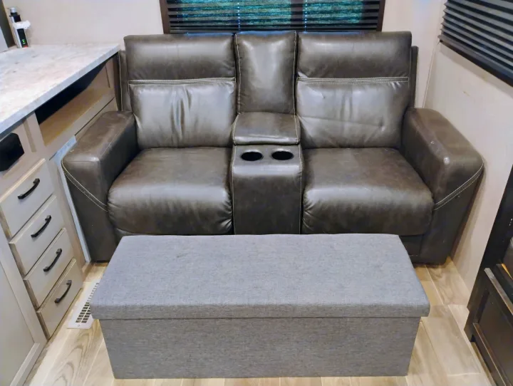 RV rental: Plush dark grey leather recliner sofa with cup holders & storage ottoman for ultimate comfort.. Jayco Jay Feather 2021