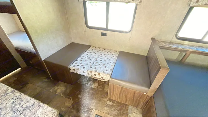 RV rental interior: dinette with patterned cushions, windows, and bunk beds.. Clipper Clipper Trailer 2016
