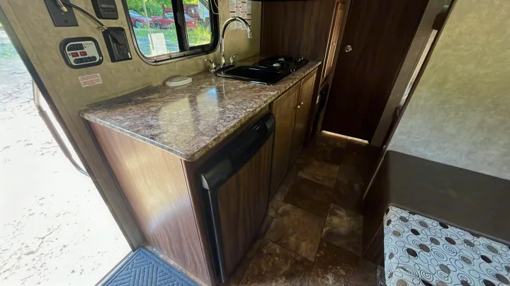 RV rental interior showing a compact kitchen with sink, stovetop, and fridge. Essential amenities for your travels.. Clipper Clipper Trailer 2016