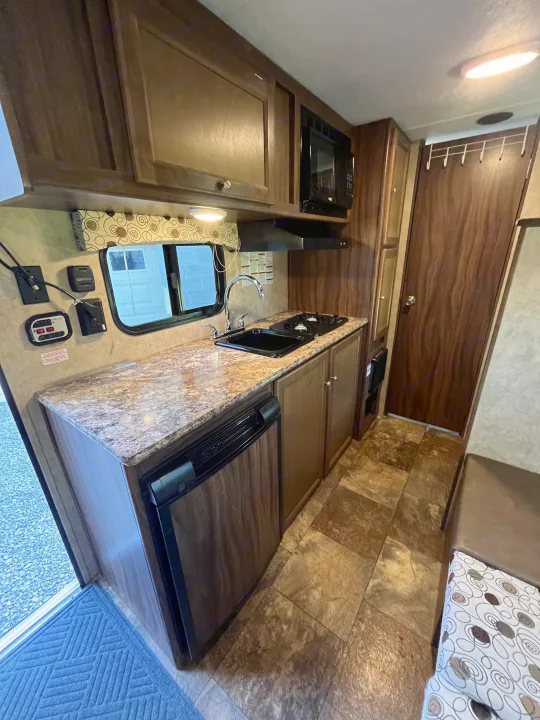 Explore this RV rental's full kitchen: microwave, sink, stove, fridge, ample counter space, and dinette.. Clipper Clipper Trailer 2016