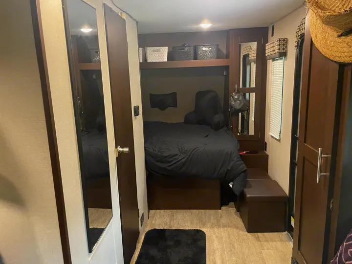 RV rental interior: Compact bedroom with lower bed, upper bunk, storage, and mirror. Ready for your adventure.. KZ Sportsmen 2019