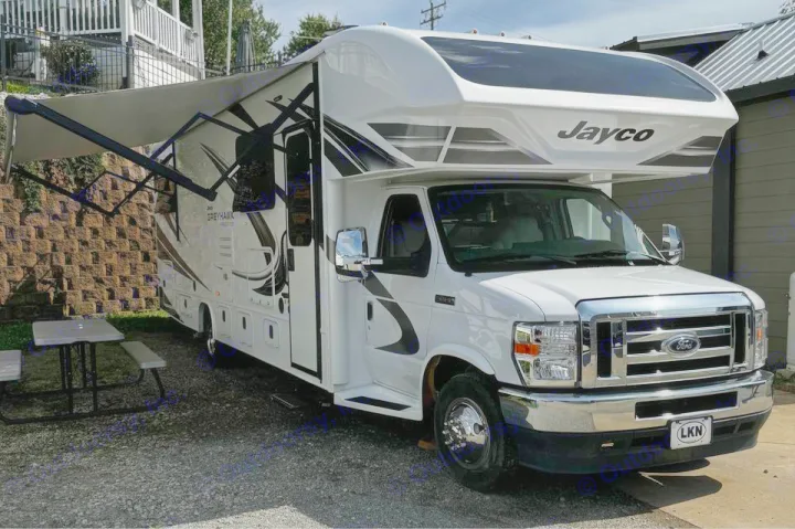 Spacious white Jayco Greyhawk RV rental parked on gravel with an extended awning, ready for travel.. Jayco Greyhawk 2021