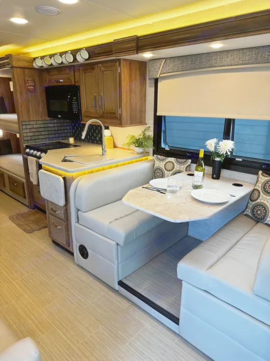 This modern rv rental boasts a full kitchen with a sink & stove, plus a bright dinette area perfect for meals.. Jayco Greyhawk 2021