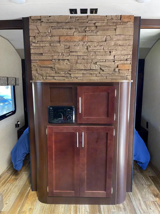 RV rental: Faux stone & wood interior partition with media player, cabinets, & sleeping areas.. Forest River Cherokee Grey Wolf 2017